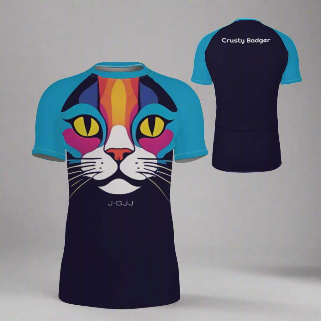 Colorful cat-themed jiu jitsu rash guard with light blue sleeves and dark blue body, featuring 'Crusty Badger' personalization on the back.