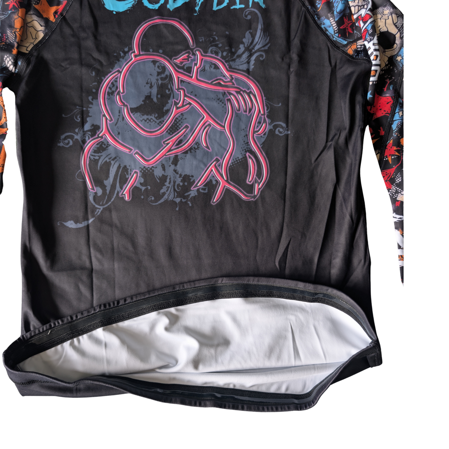 Black BJJ Rash guard showing silicon band at the hem with graphic design on a white background
