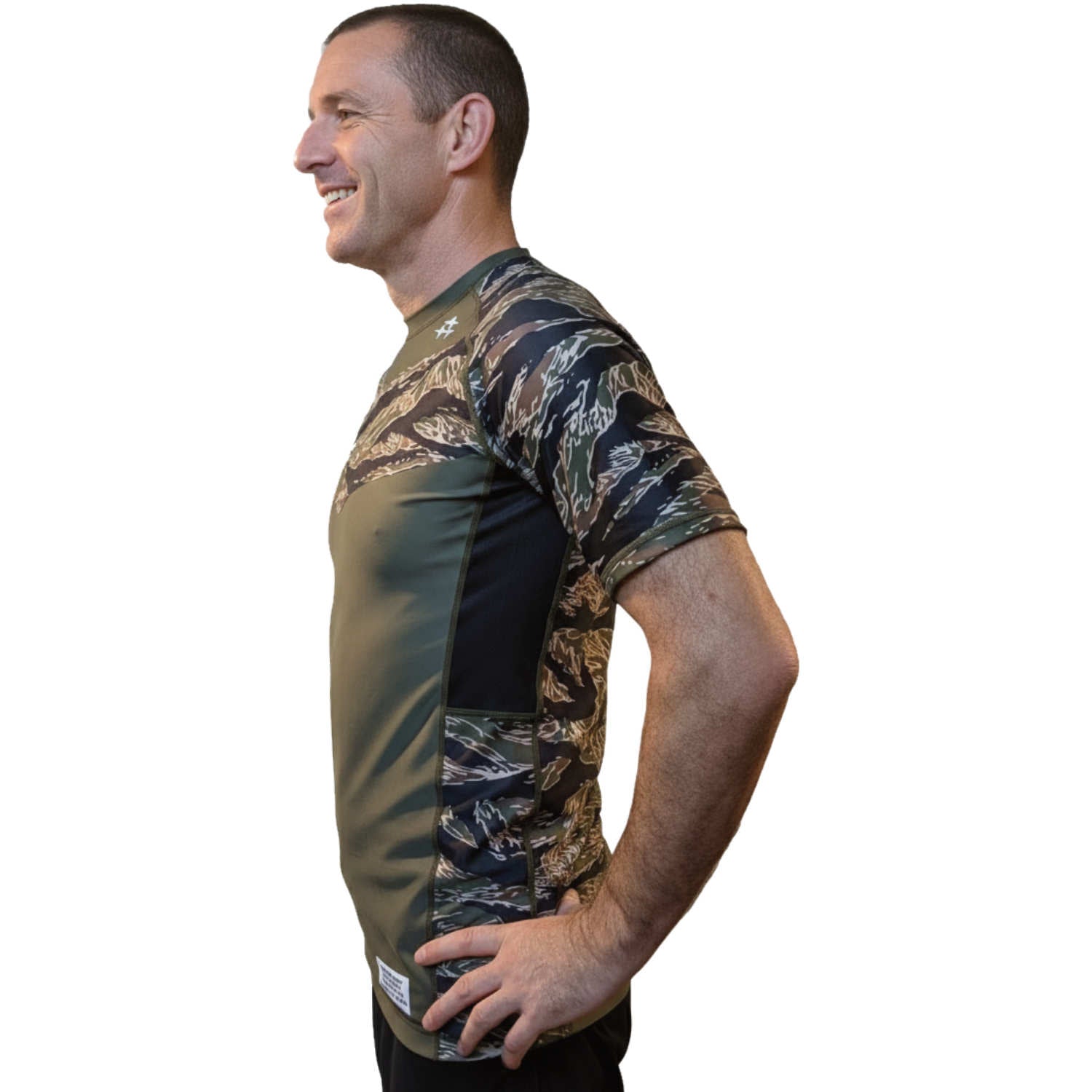 Man wearing a camouflage-patterned BJJ rash guard on a white background