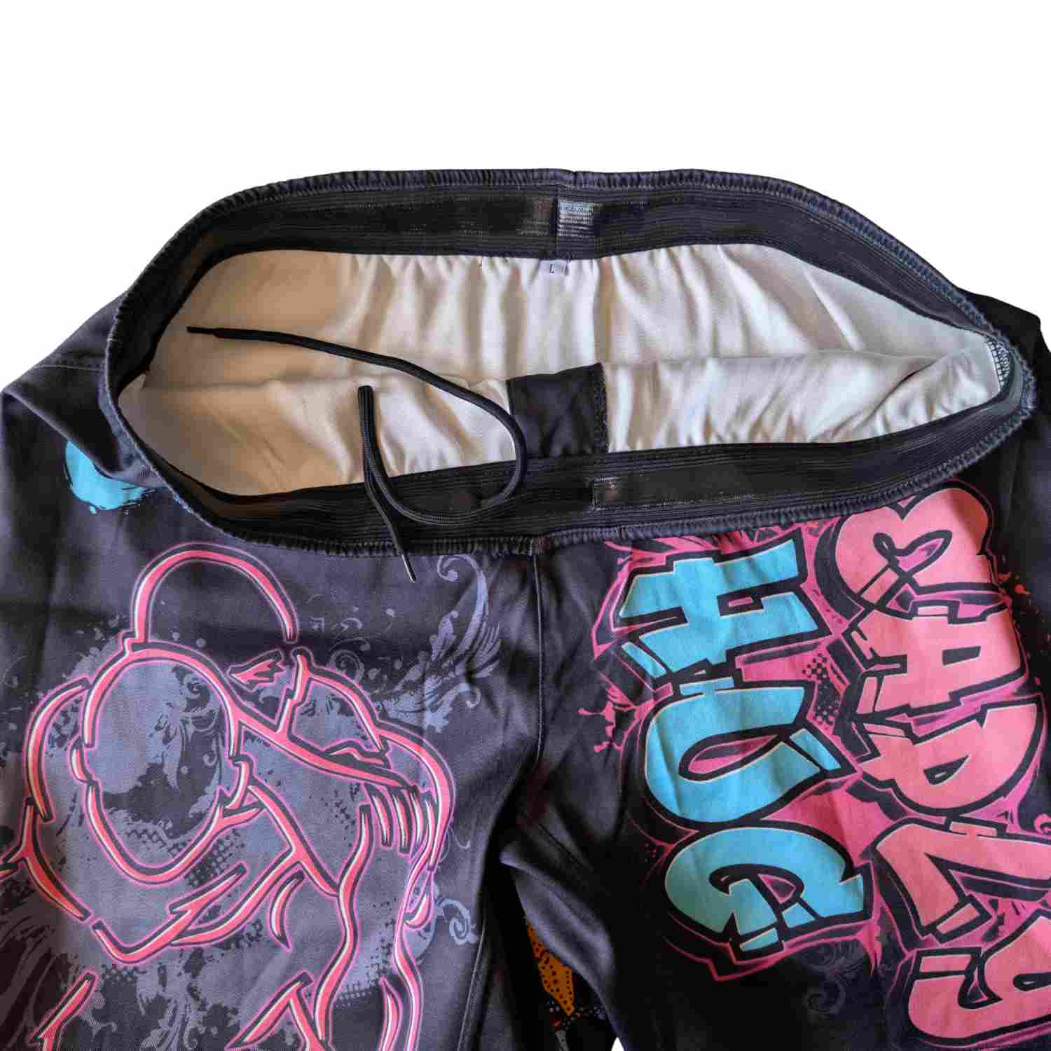 Silicone waist band on BJ shorts. White background.