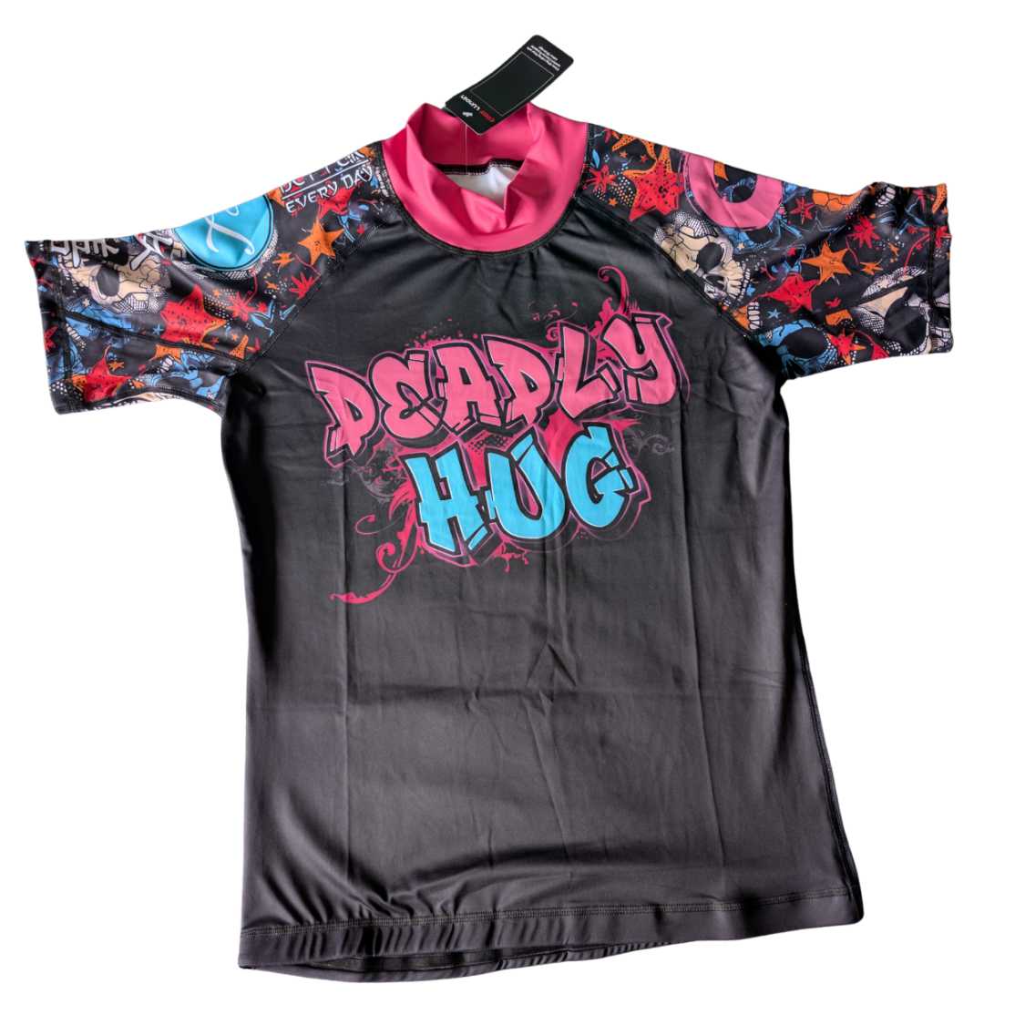 Black BJJ rash guard with colorful sleeves and 'Deadly Hug' text. White background.