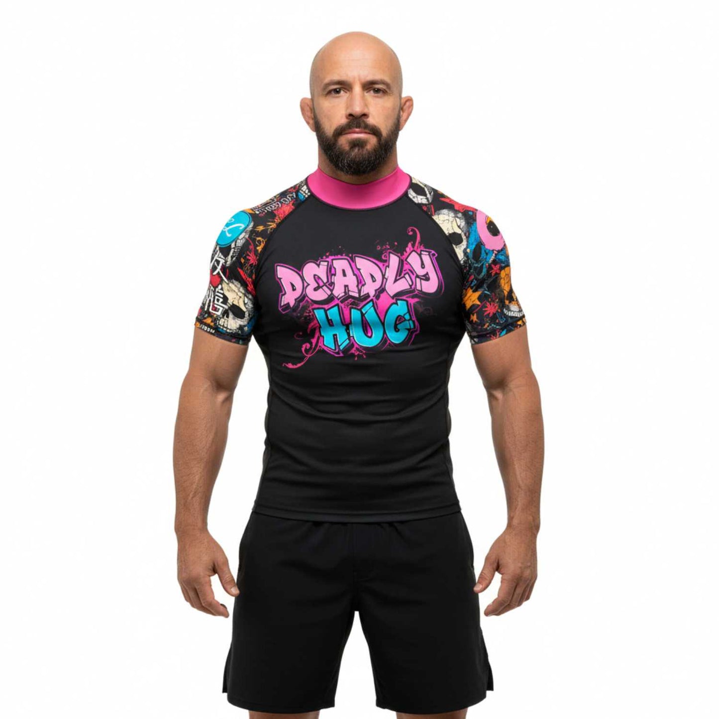 Man wearing a black BJJ rash guard with colorful graphics and text. White background