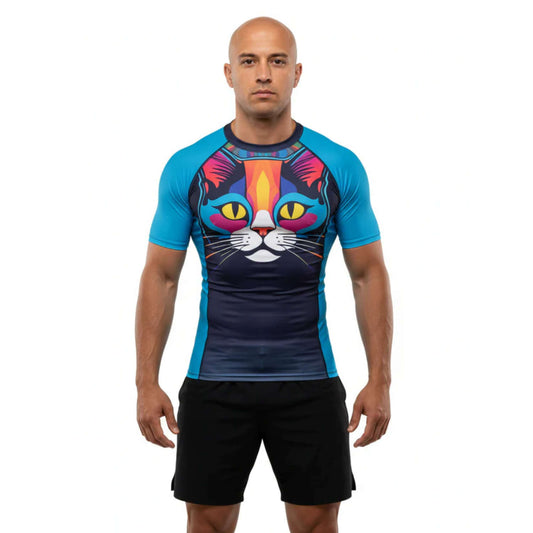 Man wearing a BJJ Rash Guard with a colorful cat design on a white background
