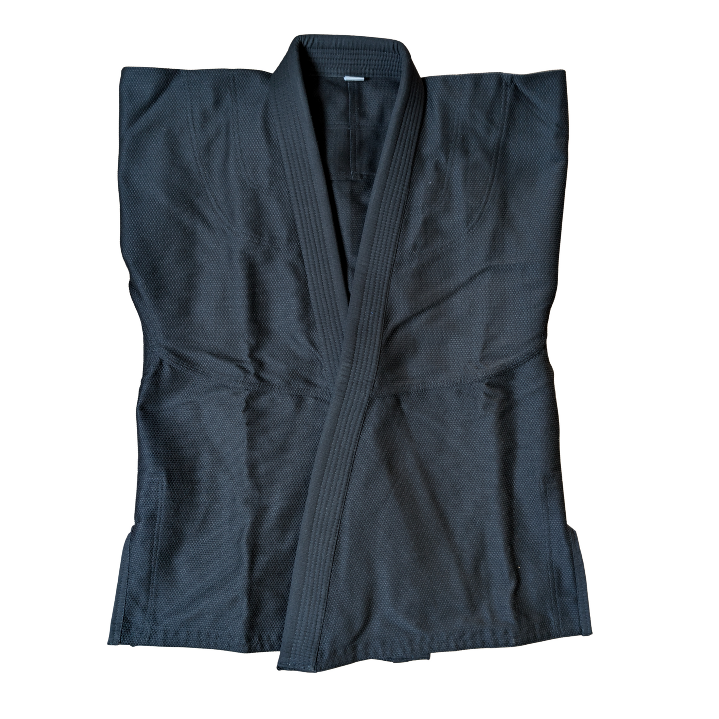 Folded raven black BJJ Gi front view on a white background