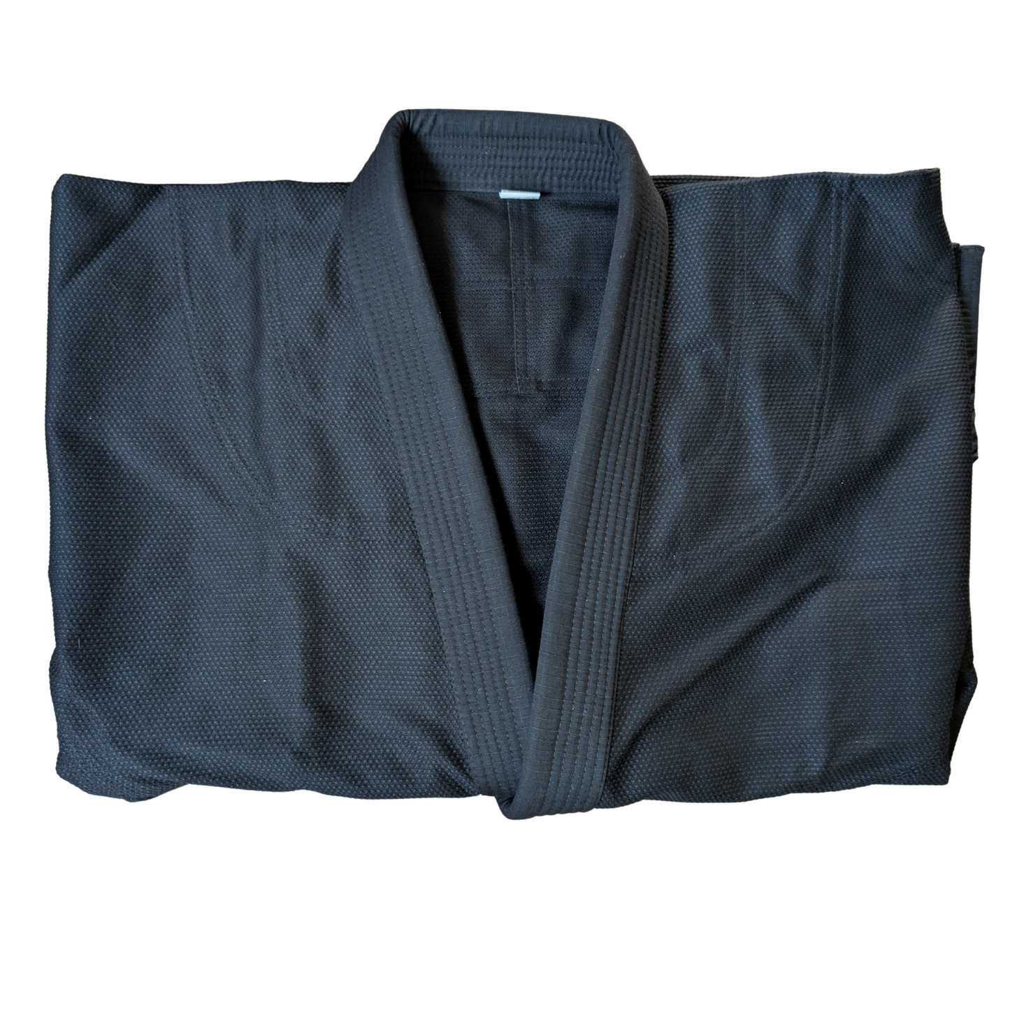 Folded black jiu jitsu gi front shot on a white background