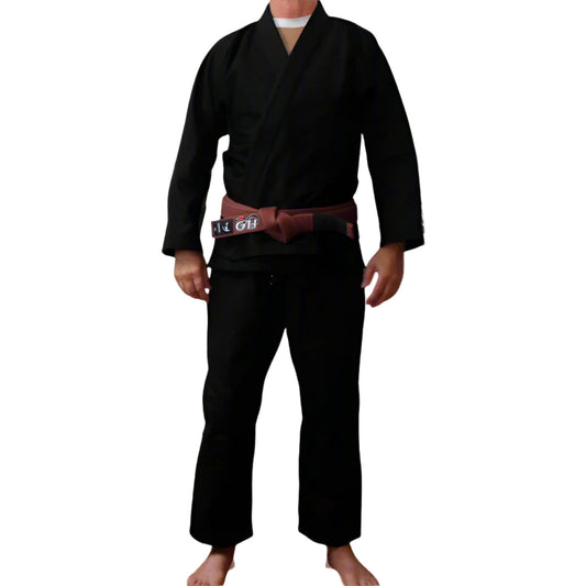 Person wearing a BJJ gi with a brown belt on a white background