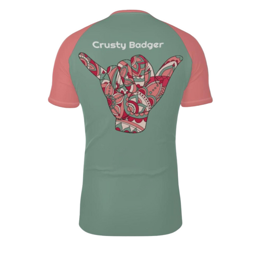 Green and pink BJJ rash guard with a colorful design and 'Crusty Badger' text on the back.