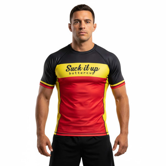 Man wearing a black, red, and yellow BJJ rash guard with text on a white background